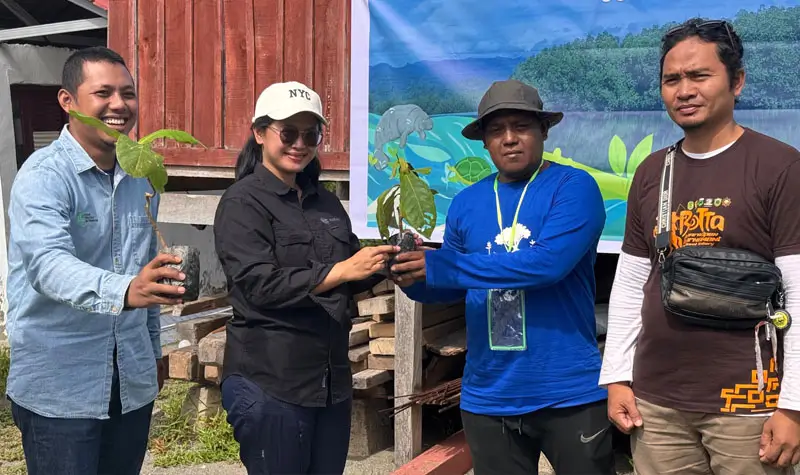 erwakilan dari Yayasan KEHATI mmenyerahkan secara simbolis bibit pohon kepada kepada pewakilan masyrakat untuk ditanam di area rehabilitasi di Donggala, Minggu (27/7/2025). (@Yayana Bonebula)